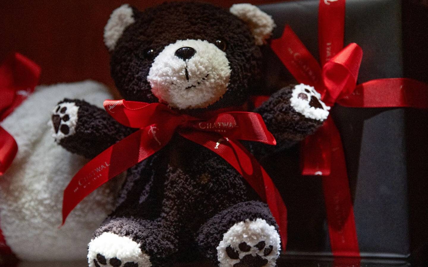 a teddy bear with a red ribbon around its neck