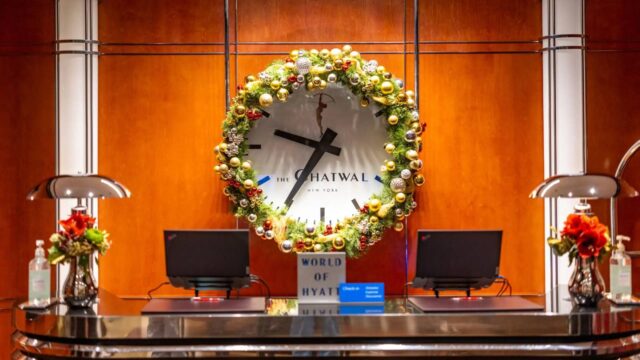 a clock with a festive wreath around it